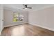 Bedroom with hardwood floors, large window, and neutral paint at 220 Semel Cir # 150, Atlanta, GA 30309
