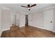 Bedroom with hardwood floors, ceiling fan, and multiple doors at 220 Semel Cir # 150, Atlanta, GA 30309
