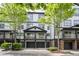 Charming townhome featuring a covered balcony, two-car garage, and manicured landscaping at 220 Semel Cir # 150, Atlanta, GA 30309