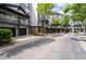 A view of a street with townhomes featuring covered balconies, garages, and attractive landscaping at 220 Semel Cir # 150, Atlanta, GA 30309