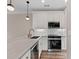 Contemporary kitchen with stainless steel oven and appliances, marble countertop, and white cabinets at 220 Semel Cir # 150, Atlanta, GA 30309