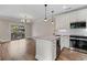 Open kitchen with white cabinets, marble countertop island, stainless appliances, and hardwood floors at 220 Semel Cir # 150, Atlanta, GA 30309