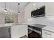 Bright kitchen with stainless steel appliances, pendant lighting, marble countertops, and white cabinets at 220 Semel Cir # 150, Atlanta, GA 30309