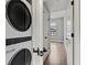 A laundry room with stackable washer and dryer, with access to storage at 220 Semel Cir # 150, Atlanta, GA 30309