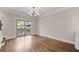 Spacious living room with gleaming hardwood floors and sliding glass doors to the outside at 220 Semel Cir # 150, Atlanta, GA 30309