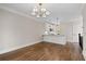 Open-concept living room with gleaming hardwood floors, modern lighting, and a view into the kitchen at 220 Semel Cir # 150, Atlanta, GA 30309