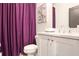 This bathroom is brightly lit and features a vanity and sink, mirror, purple shower curtain, and toilet at 3272 Stillwood Dr, Atlanta, GA 30354
