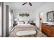 This bedroom has hardwood floors, neutral walls, a ceiling fan, and is attached to the bathroom and walk in closet at 3272 Stillwood Dr, Atlanta, GA 30354