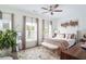 This bedroom has two windows, hardwood floors, neutral walls, a ceiling fan, and a beautiful accent wall art piece at 3272 Stillwood Dr, Atlanta, GA 30354