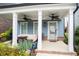 Inviting covered front porch with seating area, ceiling fans, and stylish decor at 3272 Stillwood Dr, Atlanta, GA 30354
