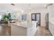 Open-concept kitchen, flowing into living and dining area, featuring a large island and stainless appliances at 3272 Stillwood Dr, Atlanta, GA 30354