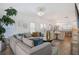 Open-concept living room with a large sectional couch, leading into the kitchen area with modern amenities at 3272 Stillwood Dr, Atlanta, GA 30354