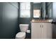 Powder room featuring designer paint, mirror, toilet and white sink at 3272 Stillwood Dr, Atlanta, GA 30354