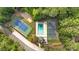Aerial view of community pool, tennis courts, clubhouse, and surrounding greenery, showcasing recreational amenities at 4853 Ridgewood Creek Nw Dr, Acworth, GA 30102