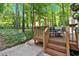 Cozy back deck with steps, adorned with festive decor, offers outdoor relaxation among lush trees at 4853 Ridgewood Creek Nw Dr, Acworth, GA 30102