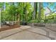 Expansive backyard with wooden deck, patio, lush greenery, and ample space for outdoor activities at 4853 Ridgewood Creek Nw Dr, Acworth, GA 30102