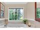Bathroom features a jetted tub, window, and marble countertop at 4853 Ridgewood Creek Nw Dr, Acworth, GA 30102