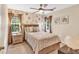 Comfortable bedroom features a ceiling fan and natural light from the windows at 4853 Ridgewood Creek Nw Dr, Acworth, GA 30102