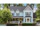 Two-story traditional home featuring a light blue exterior, neutral shutters, and a welcoming front porch at 4853 Ridgewood Creek Nw Dr, Acworth, GA 30102