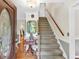 Welcoming foyer with hardwood floors, staircase, and a charming entryway table for a warm first impression at 4853 Ridgewood Creek Nw Dr, Acworth, GA 30102