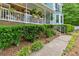 Inviting front porch adorned with hanging plants, cozy seating, and lush greenery surrounding the property at 4853 Ridgewood Creek Nw Dr, Acworth, GA 30102