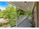 Spacious front porch with comfortable wicker seating and views of the beautifully landscaped front yard at 4853 Ridgewood Creek Nw Dr, Acworth, GA 30102