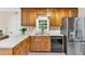 Practical kitchen with stainless steel refrigerator, black dishwasher, and ample cabinet space at 4853 Ridgewood Creek Nw Dr, Acworth, GA 30102