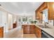 Bright kitchen featuring wooden cabinets, a stainless steel dishwasher, and a view to the dining area at 4853 Ridgewood Creek Nw Dr, Acworth, GA 30102