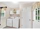 Clean and efficient laundry room with washer, dryer, storage, and a door leading to the outdoors at 4853 Ridgewood Creek Nw Dr, Acworth, GA 30102
