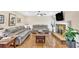 Cozy living room featuring hardwood floors, a brick fireplace, and comfortable seating, ideal for relaxation at 4853 Ridgewood Creek Nw Dr, Acworth, GA 30102