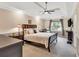 Spacious main bedroom featuring a tray ceiling, ceiling fan, and sitting area at 4853 Ridgewood Creek Nw Dr, Acworth, GA 30102