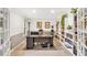 Home office with custom built-in bookshelves, a large desk, and bright natural light, perfect for productivity at 4853 Ridgewood Creek Nw Dr, Acworth, GA 30102