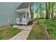 Exterior of home shows a small porch, side yard access, and well-kept landscaping at 4853 Ridgewood Creek Nw Dr, Acworth, GA 30102