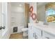 A clean bathroom with a shower-tub combo and a view outside the window at 518 Provence Gate Ln, Lawrenceville, GA 30044