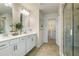 A bright bathroom with double vanity, tiled floors, a glass shower, and a walk-in closet at 518 Provence Gate Ln, Lawrenceville, GA 30044
