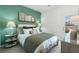 Relaxing bedroom with green accent wall, bedside tables and view of the outdoors at 518 Provence Gate Ln, Lawrenceville, GA 30044