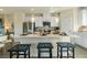 Bright kitchen with white cabinets, stainless steel appliances, and a large center island with seating at 518 Provence Gate Ln, Lawrenceville, GA 30044