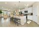 Open-concept kitchen featuring a large island, stainless appliances, and seamless flow to the living area at 518 Provence Gate Ln, Lawrenceville, GA 30044