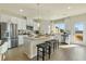 Modern kitchen with white cabinetry, stainless steel appliances, and an island with counter seating at 518 Provence Gate Ln, Lawrenceville, GA 30044