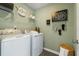 A practical laundry room featuring modern washer and dryer units with ample storage at 518 Provence Gate Ln, Lawrenceville, GA 30044