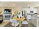 Combined dining and kitchen area with stainless appliances and cozy living space with fireplace at 518 Provence Gate Ln, Lawrenceville, GA 30044