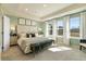 Serene main bedroom boasts tray ceilings, large windows, and plush carpeting at 518 Provence Gate Ln, Lawrenceville, GA 30044