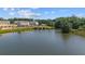 Beautiful community pond featuring a pool, surrounded by lush greenery and under construction homes at 518 Provence Gate Ln, Lawrenceville, GA 30044