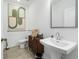 This powder room features elegant pedestal sink, lovely brown cabinet and modern fixtures at 518 Provence Gate Ln, Lawrenceville, GA 30044