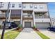 Townhome rear view with balconies, driveways, and attached garages at 2669 Caruso Way, Atlanta, GA 30339