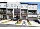 Townhome rear showcasing balconies and garages, with modern design at 2669 Caruso Way, Atlanta, GA 30339