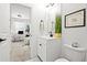 Bright bathroom featuring a modern vanity, toilet, and a glimpse into the adjacent office space at 2669 Caruso Way, Atlanta, GA 30339
