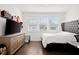 Bedroom features a large TV, hardwood floors and natural light coming from the large window at 2669 Caruso Way, Atlanta, GA 30339