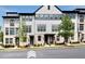 Charming townhome showcasing a blend of brick and siding, complemented by lush landscaping at 2669 Caruso Way, Atlanta, GA 30339