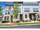 Attractive townhome front with brick accents, dark trim, and manicured green landscaping at 2669 Caruso Way, Atlanta, GA 30339